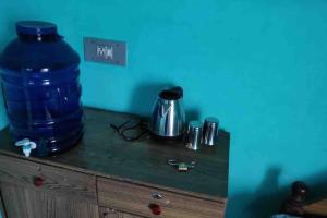 a table with a large blue barrel on top of it at Roof top couple stay cozy in Mysore