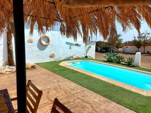a swimming pool in front of a house at Casa Elsa in Puerto del Rosario
