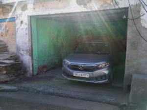 a car is parked inside of a garage at YATRA HOMESTAY Joshimath in Joshīmath