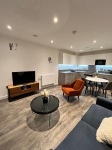 a living room with a couch and a table at One bedroom Apartment in Barking