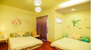 Vuode tai vuoteita majoituspaikassa Yilan Greenbird of Happiness B&B