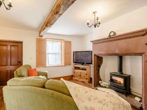 a living room with a couch and a fireplace at 1 bed property in Allonby 28790 in Allonby