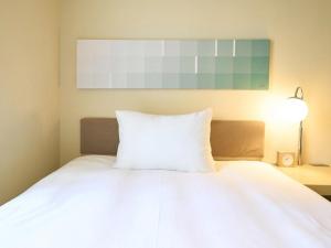 Postel nebo postele na pokoji v ubytování Hotel Resol Ikebukuro