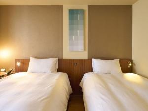 Postel nebo postele na pokoji v ubytování Hotel Resol Ikebukuro