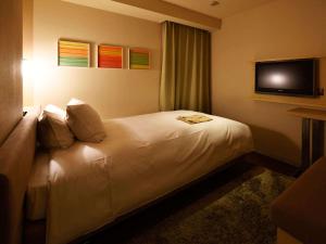 Postel nebo postele na pokoji v ubytování Hotel Resol Ikebukuro