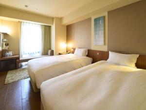 Postel nebo postele na pokoji v ubytování Hotel Resol Ikebukuro