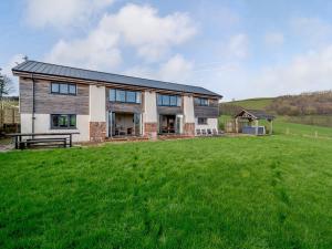 a house with a green field in front of it at 5 Bed in Tiverton 48151 in Cadeleigh