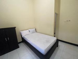 Ένα ή περισσότερα κρεβάτια σε δωμάτιο στο OYO Life 93258 Kos Sahabat