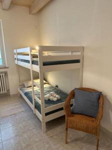 a room with two bunk beds and a chair at Affittacamere Il Cortile in Chiaravalle