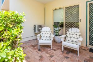 two white chairs sitting on a patio at Unit 10 Sails on Horseshoe in Horseshoe Bay