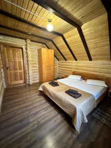 una camera da letto con letto in una camera in legno di Oberig Apartmens a Vorokhta