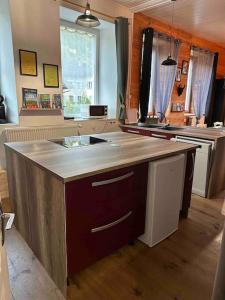 a kitchen with an island in the middle of it at Appart. spacieux et lumineux 4 pers. in Morez