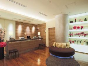 a lobby with a waiting area with a flower shop at Hotel Resol Ikebukuro in Tokyo