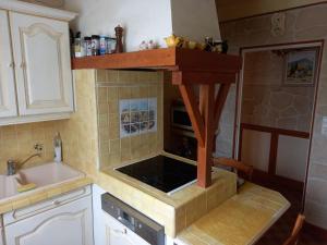 a kitchen with a sink and a stove top oven at La maison du bonheur in Beaumes-de-Venise