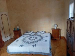 a bedroom with a bed and two night stands at La maison du bonheur in Beaumes-de-Venise