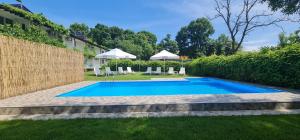 a swimming pool in the yard of a house at Hotel Char in Primorsko