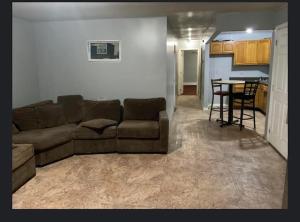 a living room with a couch and a table at Room in a Beach House with King Size bed in a landlord hosted three bedroom apartment in Edgemere