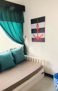 a small bed in a room with a flag on the wall at Renovated 2 Bedroom Seavilla for 6pax in Pantai Cenang