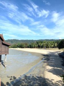 a view of a beach with palm trees and water at Renovated 2 Bedroom Seavilla for 6pax in Pantai Cenang