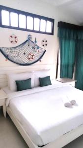 a bedroom with a bed with a hammock on the wall at Renovated 2 Bedroom Seavilla for 6pax in Pantai Cenang