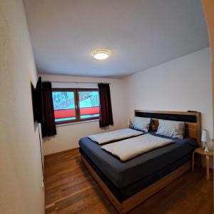 um quarto com uma cama e uma janela em Ferienwohnung Prama em Going