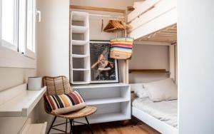 a tiny house with a bed and a desk at AMARA Family & Surf with Oceanview and Pool in Tarifa