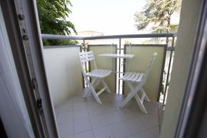 dwa krzesła i stół na balkonie w obiekcie Residence Eurogarden w Rimini