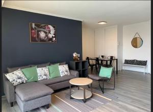 a living room with a couch and a table at South bank Serviced Apartments in Brisbane