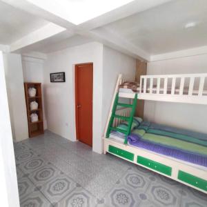 a bedroom with two bunk beds in a room at Apartment in Holidays Beach Resort in Bolinao