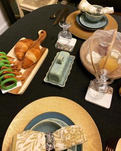 a black table topped with plates of food and bread at Belle Chambre in Triac-Lautrait