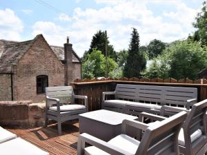 a patio with a table and chairs on a deck at 4 Bed in Bewdley OSHIP in Highley