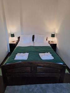 een slaapkamer met een bed met twee handdoeken erop bij Apartament Borsec in Borsec