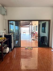 a living room with a door open to a patio at grandmabalcony in Prachuap Khiri Khan