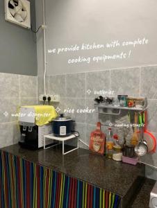 a kitchen with a counter top with words on the wall at homestayfidagerik in Gerik