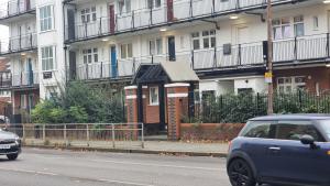 a car parked in front of a row of apartment buildings at 3 bed flat O2 arena Dyson house in London