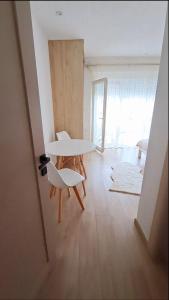 a room with a table and two chairs in a room at Rooms Lida & Friendly home in Plav