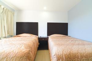 Postel nebo postele na pokoji v ubytování Xpress Inn & Extended Stays