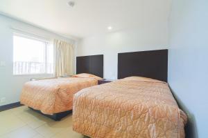 Postel nebo postele na pokoji v ubytování Xpress Inn & Extended Stays