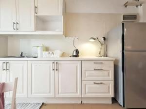 a kitchen with white cabinets and a refrigerator at Greenhill Resort Cameron Highland in Tanah Rata +51 photos