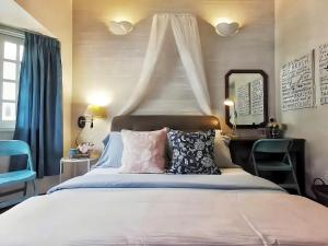 a bedroom with a bed and a desk and a mirror at Greenhill Resort Cameron Highland in Tanah Rata