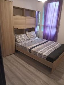 1 dormitorio con cama con dosel y ventana en Appartement avec un grand parking, en Montélimar