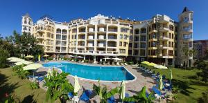 a hotel with a swimming pool in front of a building at Diamond Palace in Sunny Beach