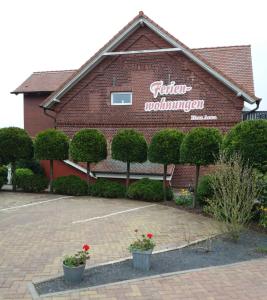 a red brick building with a sign on it at Ferienhaus Anna in Neuendorf