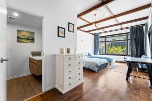 a bedroom with a bed and a desk at Albert.T Home in Auckland