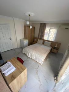 a bedroom with a bed and a table in it at Menekşe Apart 1 in Trabzon