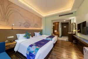 Voodi või voodid majutusasutuse Overseas Chinese Town Nanyang Inn toas