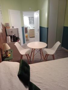 a room with a bed and a table and chairs at chez lulu in Saint-Saturnin-les-Apt +10 photos