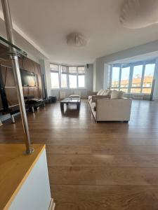 a large living room with a couch and a table at WhiteFort apartment in Almaty