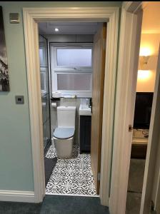 a small bathroom with a toilet in a room at Private self-contained flat with shared entrance in London
