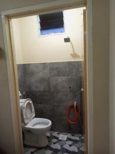 a bathroom with a toilet and a window at Bilik Bajet RM70-RM90 in Kuala Terengganu